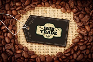 Fair Trade graphic against coffee beans with oval indent for copy space